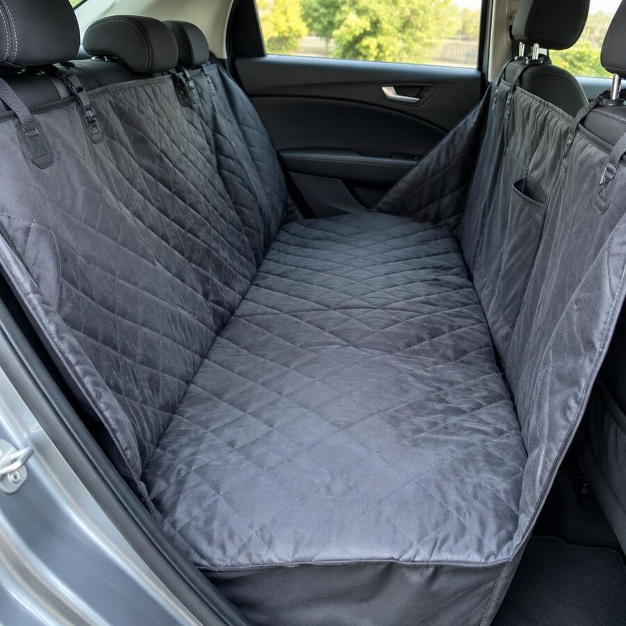 Grey quilted hammock-style dog seat cover fitted across a car back seat