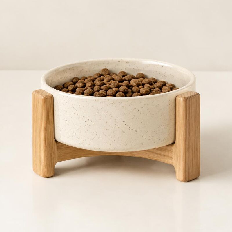 Speckled cream ceramic food bowl in an oak stand